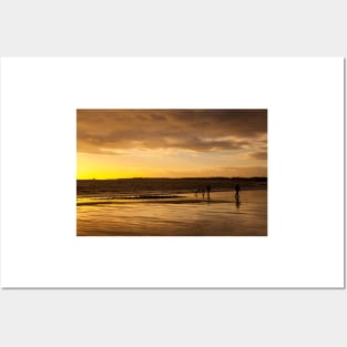 Dog walkers on the beach at sunrise Posters and Art